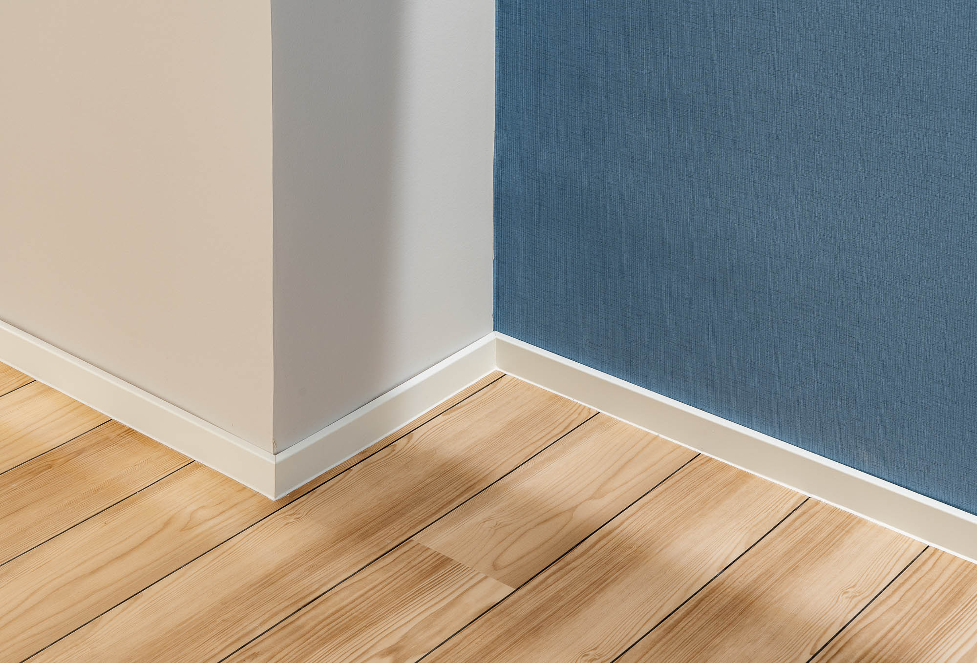 Wanddetail mit Holzboden und blauer Farbe