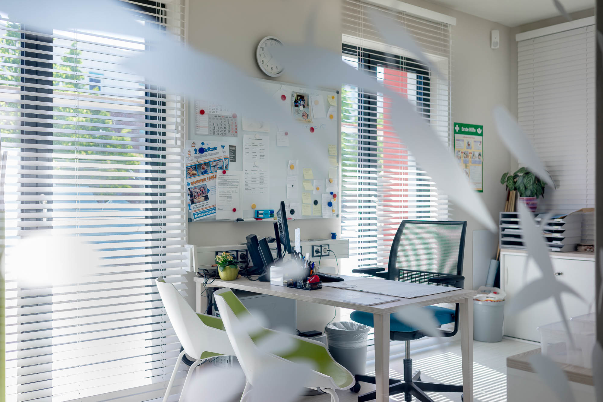 Modernes Büro mit weißen Möbeln und Glasfronten