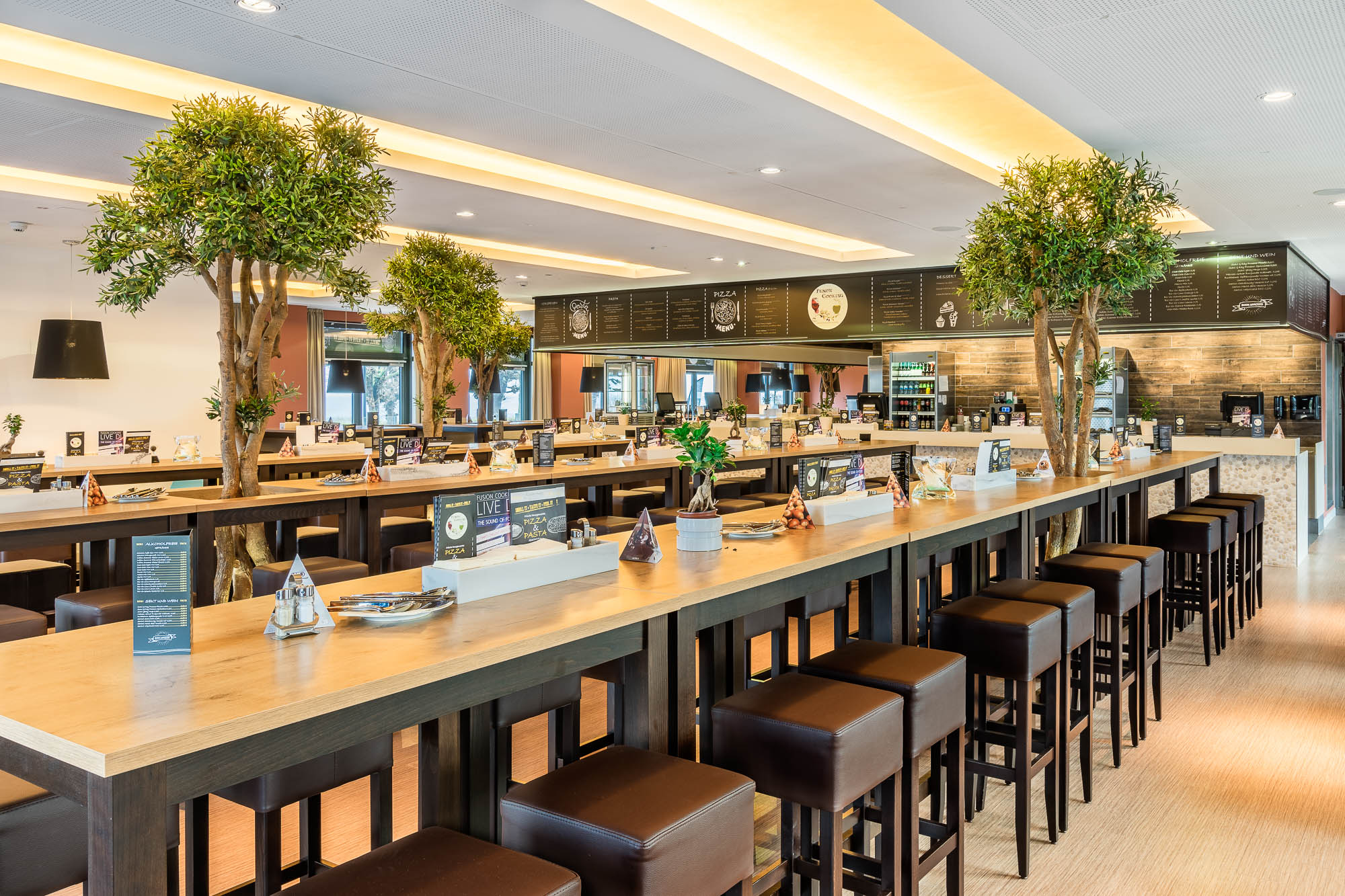 Restaurant mit langen Tischen und elegantem Interieur