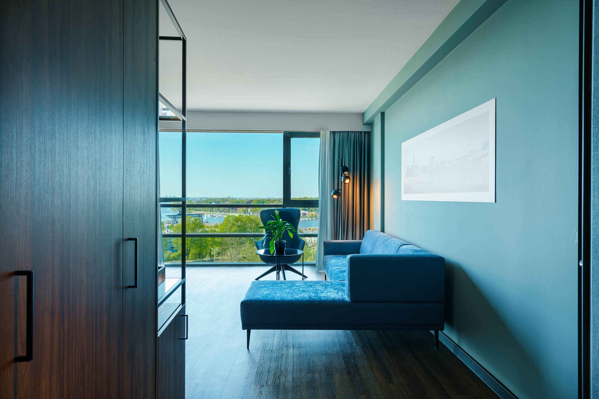 Hotelflur mit Blick auf Sitzbereich und Fensterfront